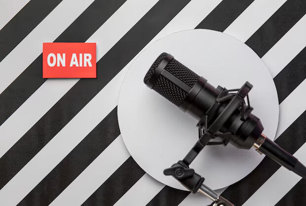 Podcast on air red title next to black microphone